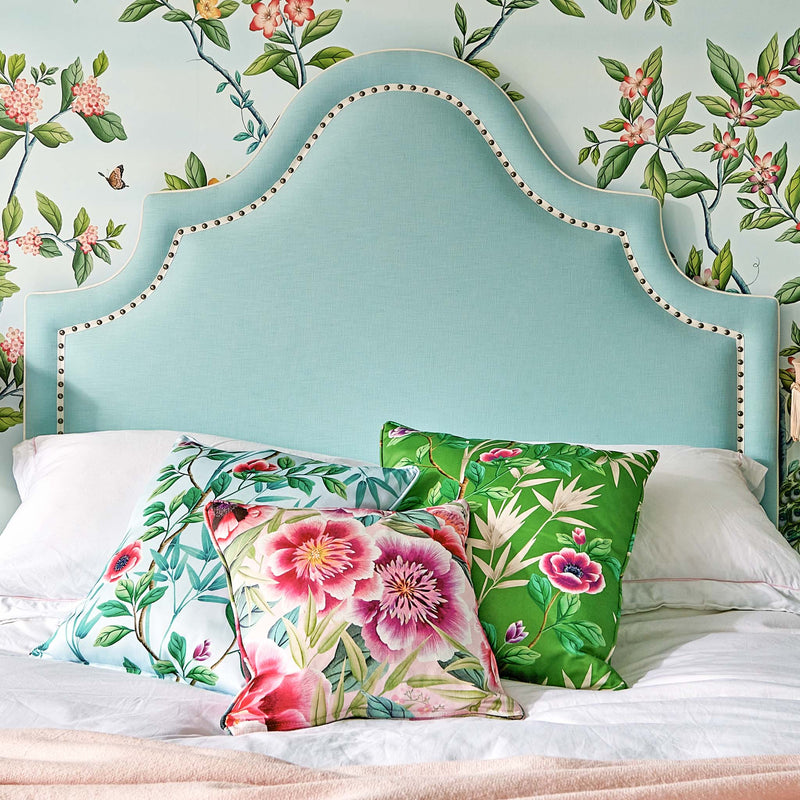 green chinoiserie fabric featuring bamboo and flowers on cushion in grandmillennial style bedroom