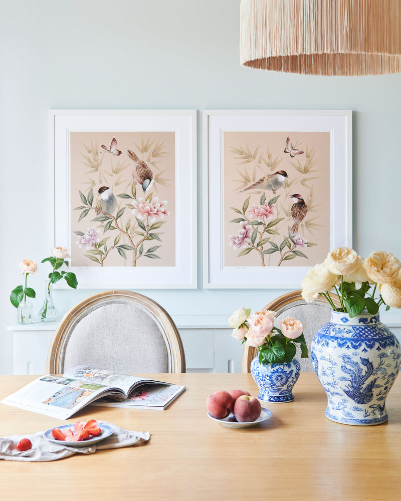 The Rosie and Bonnie art prints by Diane Hill framed side by side above a dining table, creating an elegant impact in a dining space
