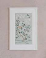 The Mariya art print in pebble blue, in a classic white frame against a pink wall. A celebration of butterflies, bamboo and botanicals, Mariya is a beautiful modern chinoiserie art print which was originally hand-painted onto pure silk, featuring delicate leaves, peonies in tones of blue and bronze, and an abundance of butterflies