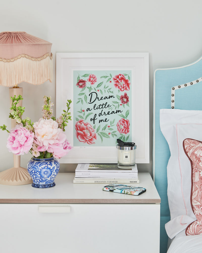 framed blue and pink vintage-style chinoiserie wall art print featuring flowers and leaves with the quote 'dream a little dream of me' hung on wall