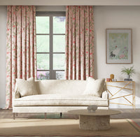 pink botanical fabric featuring chinoiserie style birds, branches, and butterflies on curtains in modern living room