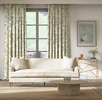 botanical fabric featuring chinoiserie style birds, branches, and butterflies on curtains in modern living room