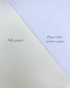 Comparison photo of handmade silk paper compared to plain white paper. To show the off white creamy colour of silk paper