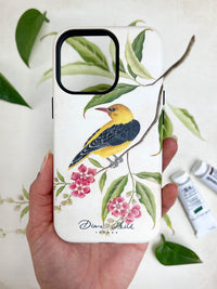 hand holding Luxury phone case featuring vintage style botanical bird on tree branch with flowers