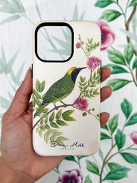 hand holding Luxury phone case featuring vintage style botanical bird on tree branch with flowers