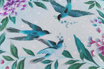 close up of blue chinoiserie wall art print featuring three vintage inspired birds surrounded by leaves and flowers
