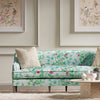 blue chinoiserie fabric featuring bamboo and flowers on sofa in modern living room