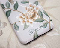 close up of Luxury phone case featuring vintage style butterflies and flower branches with a bamboo background