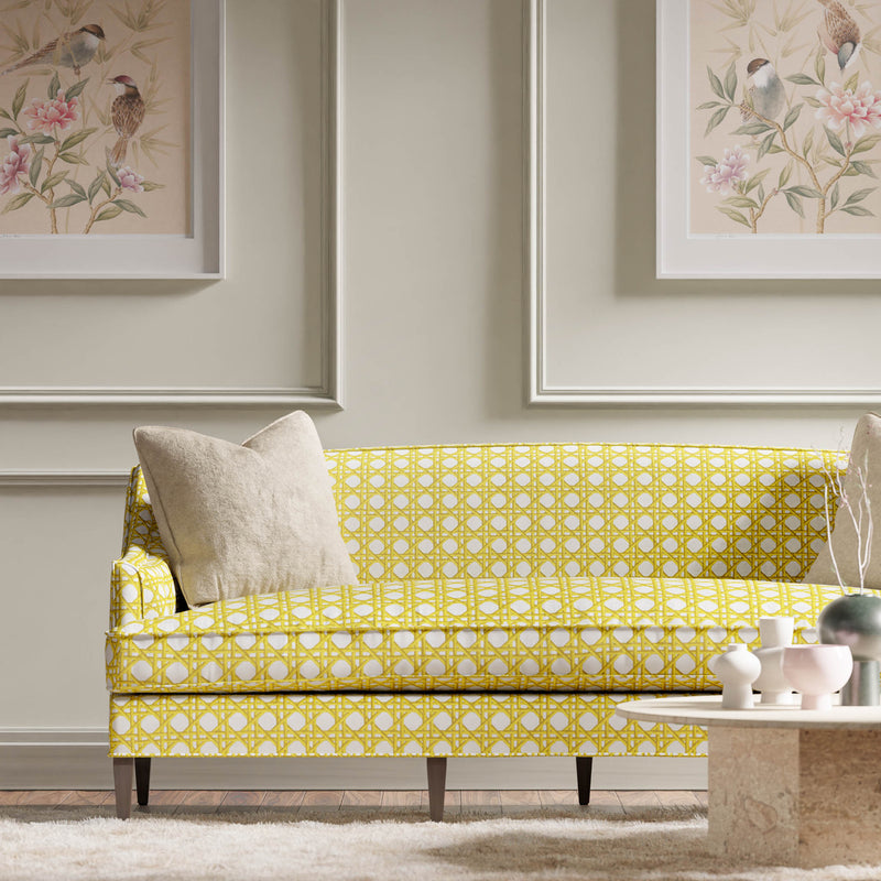 yellow geometric fabric featuring chinoiserie trellis design on sofa in modern living room