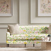 yellow botanical fabric featuring chinoiserie style fruits and flowers on sofa in modern living room