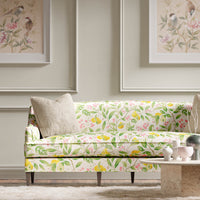 yellow botanical fabric featuring chinoiserie style fruits and flowers on sofa in modern living room