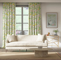 yellow botanical fabric featuring chinoiserie style fruits and flowers on curtains in modern living room