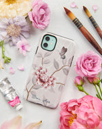 The Mariya phone case by Diane Hill. Mariya is an incredibly graceful, feminine chinoiserie design – perfect for adding a dash of sophistication to your phone. A celebration of butterflies, bamboo and botanicals in pretty pink tones. A styled flatlay set with peonies and paintbrushes