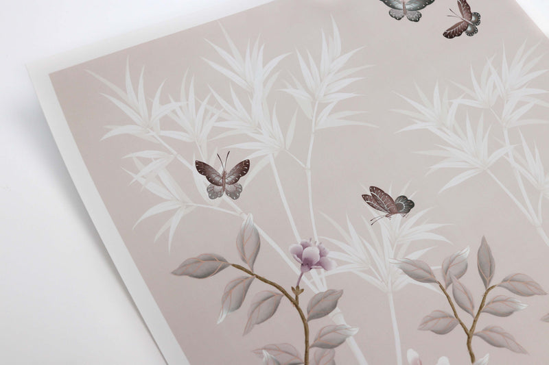 close up of soft pink framed chinoiserie wall art prints featuring butterflies, flower branches, and bamboo