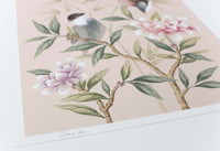 close up of blush pink chinoiserie wall art print featuring vintage style birds, butterfly and flower branches with a bamboo background