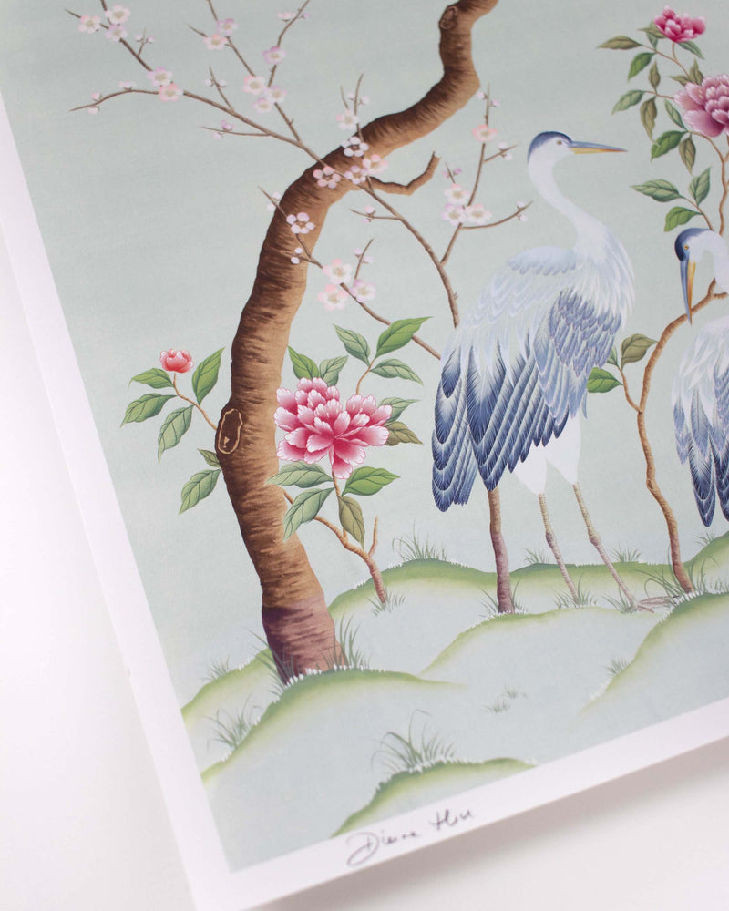 Close up detail of Diane Hill's Chinoiserie art print, Susan. Featuring two blue heron birds and pink peonies . This close up shows the luxurious soft printed paper and Diane Hill signature in the corner.