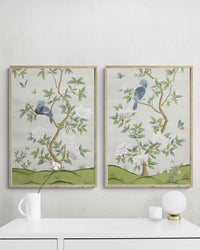 pair of two framed ivory and green botanical chinoiserie wall art prints with flowers and birds in Chinese painting style on wall