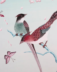 close up of blue chinoiserie art print featuring colourful birds on blossom branch, butterflies and fruit