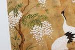 close up of Japanese style chinoiserie wall art print featuring cranes and wisteria tree on gold background
